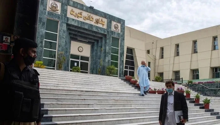 A lawyer walks past in front of the Peshawar High Court building. — AFP/File