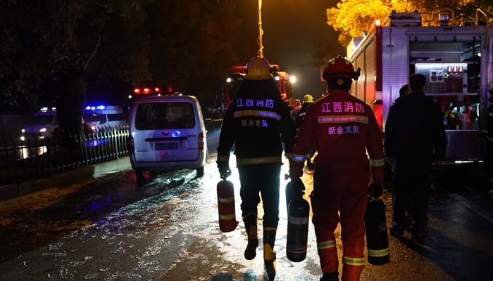 Firefighters work at the site of a building fire in Xinyu City, east Chinas Jiangxi Province, January 24, 2024. — Xinhua