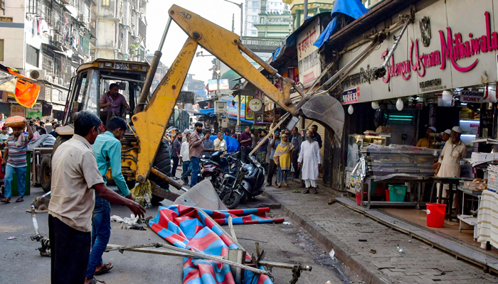 This photograph taken on January 24, 2024 shows Brihanmumbai Municipal Corporation authorities demolishing structures on the facade of an eatery near Minara Masjid mosque in Mumbai. — AFP