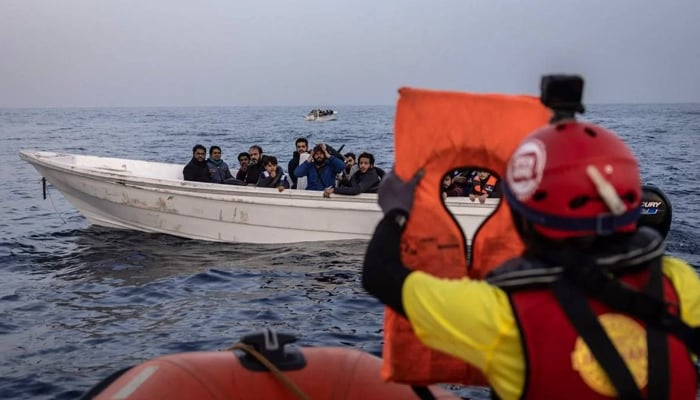 Migrants from Syria and Bangladesh are assisted on January 18, 2024, by a rescue team from the Spanish NGO Open Arms, off the Libyan coast, in international waters of the central Mediterranean. — AFP