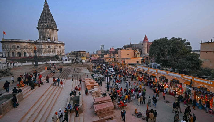 Devotees walk towards the newly inaugurated temple of Hindu deity Ram in Ayodhya on January 23, 2024. — AFP