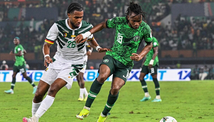 Cameroons defender Enzo Tchato (L) fights for the ball with Nigerias forward Ademola Lookman during the Africa Cup of Nations (CAN) 2024 round of 16 football match between Nigeria and Cameroon at the Felix Houphouet-Boigny Stadium in Abidjan on January 27, 2024. —  AFP