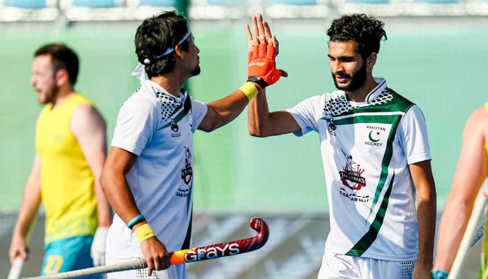 Pakistan players celebrate after scoring a goal. — FIH