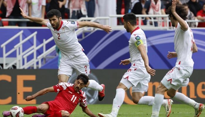 Jordans Yazan Al-Naimat fights for the ball on the ground. — AFP/File