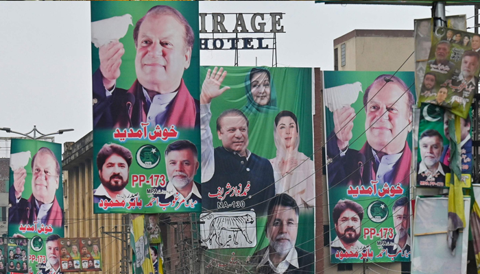 A street is festooned with posters of Pakistan´s former Prime Minister and leader of the Pakistan Muslim League (PML) party, Nawaz Sharif in Lahore on February 4, 2024. — AFP