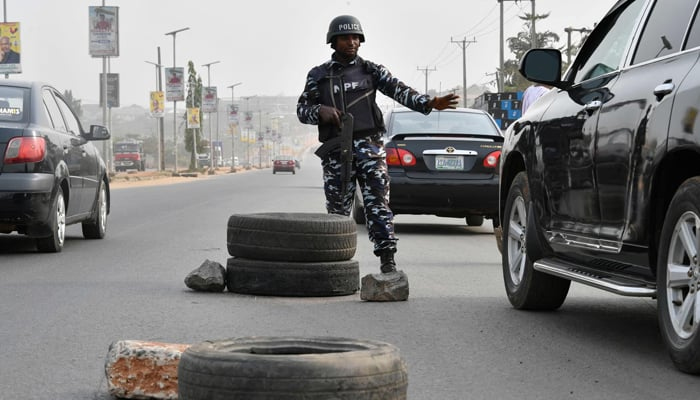 An officer stops a car in Anambra state, Nigeria. — AFP/File