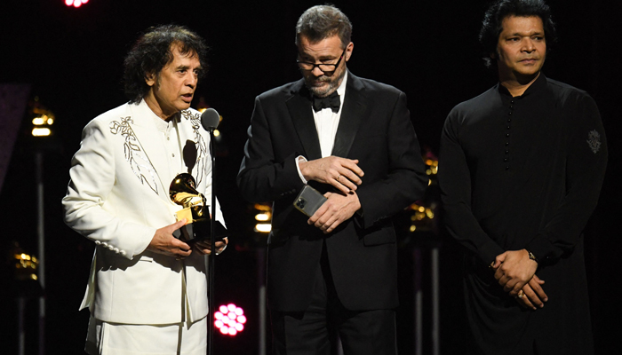 (From L) Zakir Hussain, Edgar Meyer and Rakesh Chaurasia accept the Global Music Performance award for Pashto on stage during the 66th Annual Grammy Awards pre-telecast show at the Crypto.com Arena in Los Angeles on February 4, 2024. — AFP