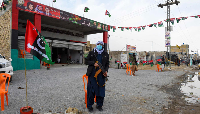 Security personnel stand guard near the Pakistan Peoples Party (PPP) election office in Quetta on February 3, 2024. — AFP