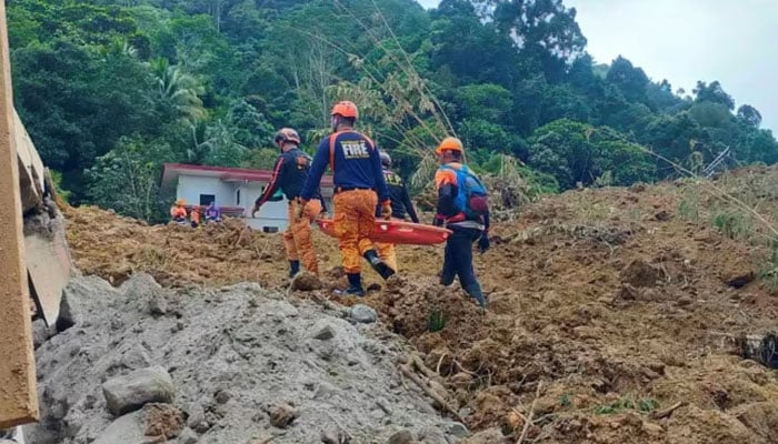 Rescue workers carry a stretcher after the landslide-hit village of Masara in Mako, Davao de Oro province, southern Philippines on February 8, 2024. — AFP