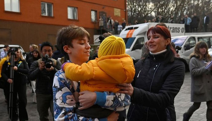 Inessa met her son Vitaly after the bus delivering him and more than a dozen other children back from Russian-held territory arrived in Kyiv on March 22, 2023. — AFP