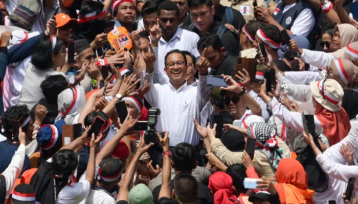 Presidential and vice presidential candidates, Anies Baswedan and Muhaimin Iskandar, greet their supporters during their campaign rally at the Jakarta International Stadium. — AFP/File