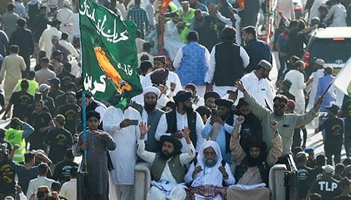 Saad Hussain Rizvi, leader of Tehreek-e-Labbaik Pakistan (TLP), waves to supporters during a protest against the hike in price of essential commodities in Karachi. — AFP/File