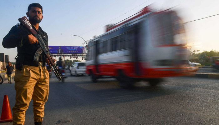 A policeman stands guard along a street in Karachi on February 1, 2024. — AFP