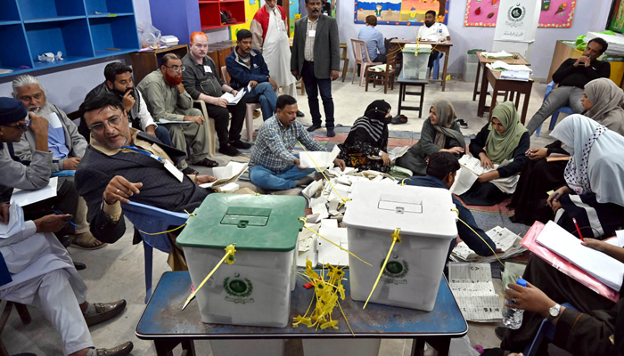 Polling staff counts votes in a polling station during General Elections 2024 on February 8, 2024. — APP