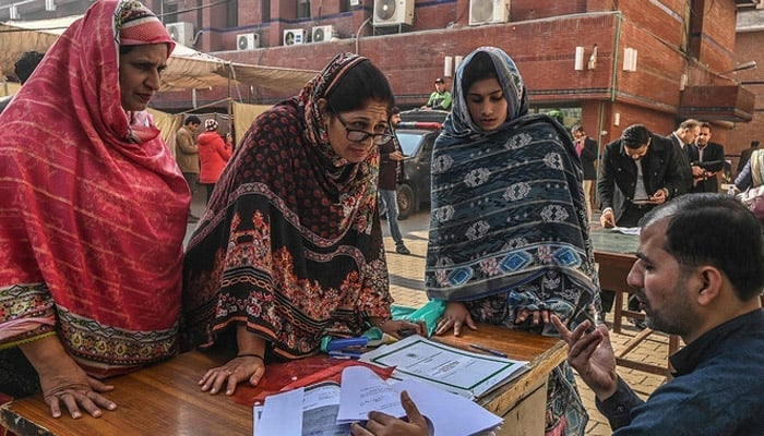 Candidates for the seats reserved for women of the Provincial Assembly receive their nomination papers for the upcoming general election at the election commission office in Lahore on December 20, 2023. — AFP