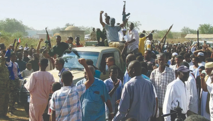 Supporters of the Sudanese popular resistance, which backs the army, raise their weapons in Gedaref town. — AFP/File