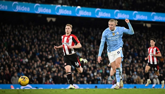 Manchester Citys Norwegian striker Erling Haaland shoots and scores his team first goal during the English Premier League football match between Manchester City and Brentford at the Etihad Stadium in Manchester, north west England, on February 20, 2024. — AFP