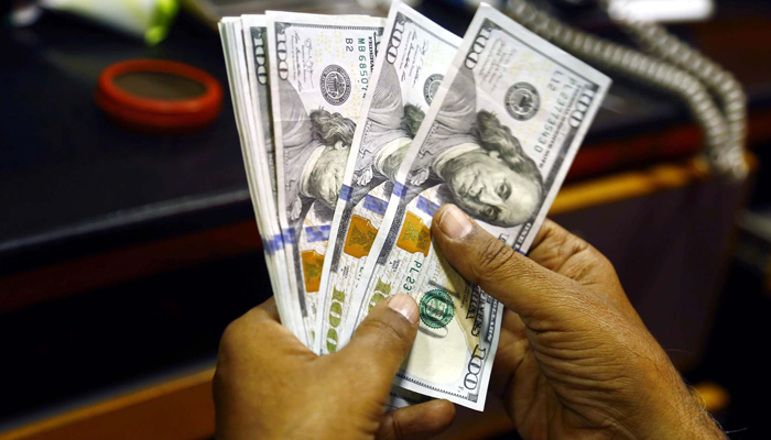 Currency dealer trader counts the US dollar notes at a currency exchange office, in Karachi July 13, 2023. — PPI