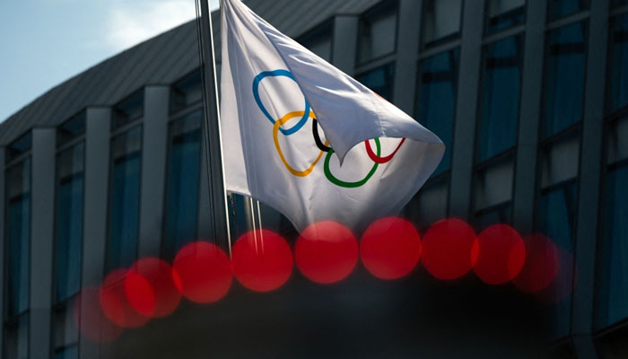 This file photo taken on March 8, 2021 shows the Olympic flag floating next to the headquarters of the International Olympic Committee in Lausanne. — AFP