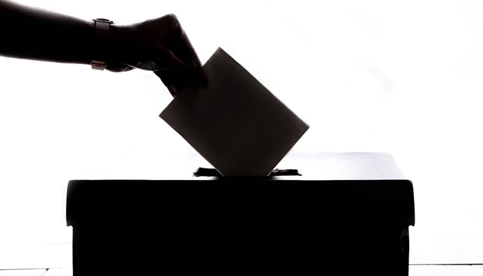 A representational image o a person casting a ballot. — Unsplash