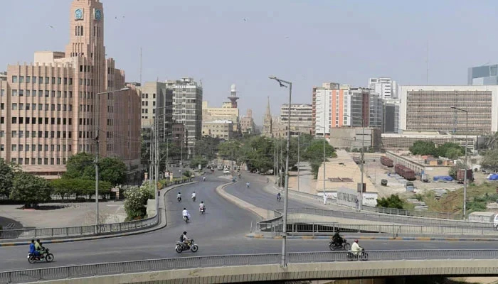 Commuters make their way through a partially deserted bridge in Karachi. — AFP/File