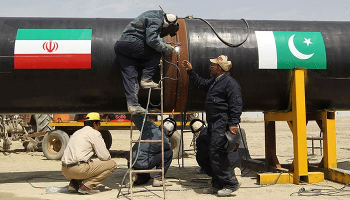 Workers can be seen working on a gas pipeline between Pakistan and Iran. — AFP/File
