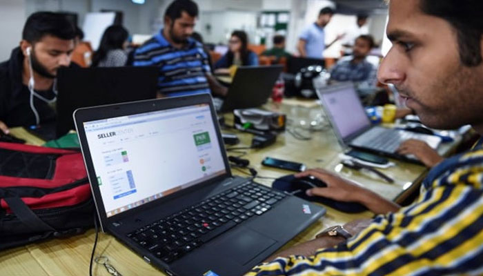 Pakistani employees of online marketplace company at work in Karachi. — AFP/File