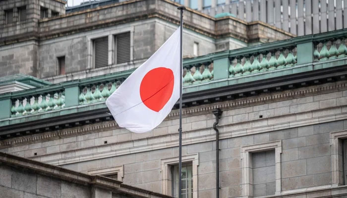 The Japanese national flag is seen at the Bank of Japan headquarters in Tokyo. — AFP/File