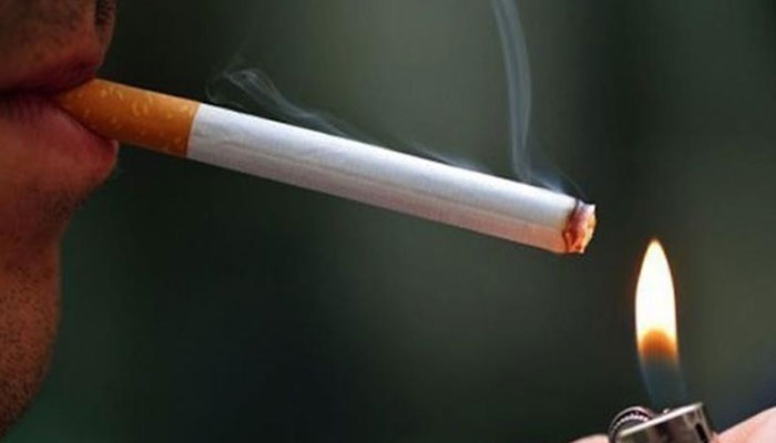 A person can be seen while smoking. — AFP/File