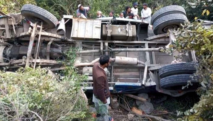 People rescue victims of a passenger bus accident at a road, as a passenger bus fell into a ravine in Sarbrot area of Haripur on February 27, 2024. — Online