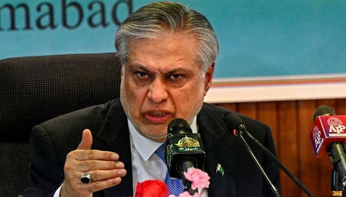 Former Finance Minister Ishaq Dar during a press conference. — AFP/File