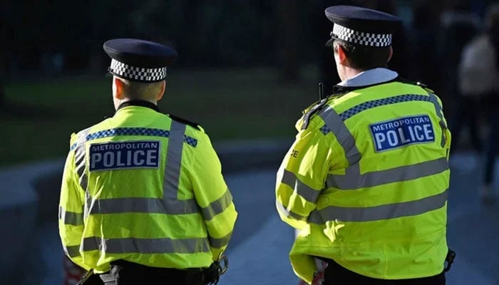 Police officers stand guard in central London, on January 21, 2023. — AFP