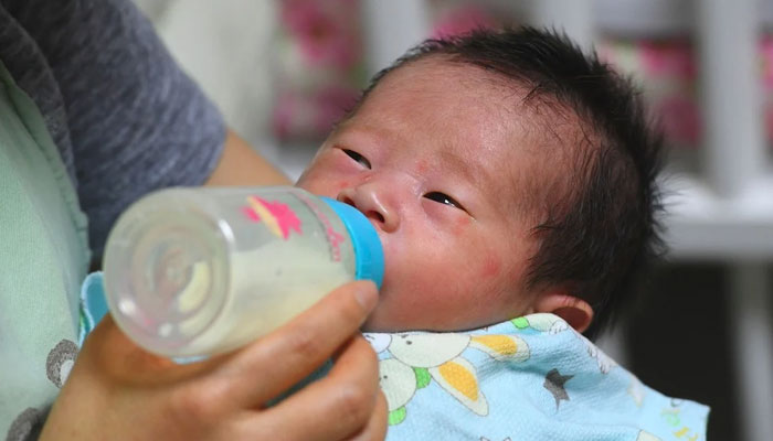 This image shows a South Korean newborn, who drinks milk. — AFP/File