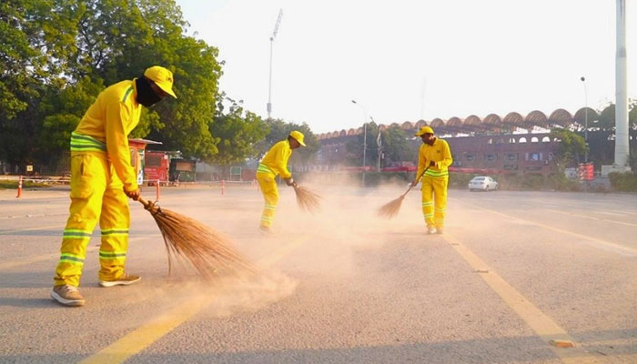 Lahore Waste Management Company (LWMC) workers cleaning the streets. — APP/File