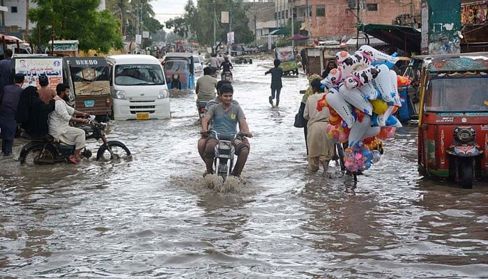 In this undated photo, a road is seen submerged under rainwater in Karachi. — APP File