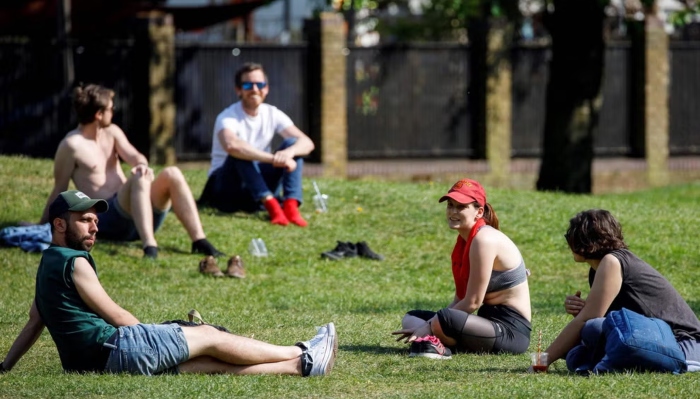 People are enjoying sunny weather in England in this file image. —AFP/File