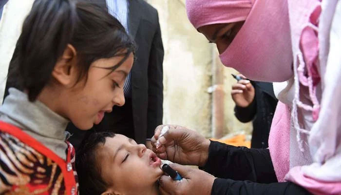 A lady health workers administers anti-polio drops to a child. — The News/File