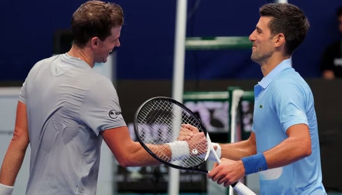 Canadas Vasek Pospisil (left) and Serbias Novak Djokovic shake hands after their mens singles quarter-final tennis. — AFP/File