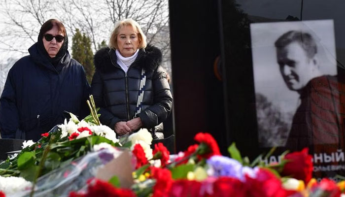 In this photo, Alexei Navalnys mother and mother-in-law stand at their sons grave on March 2, 2024. — AFP