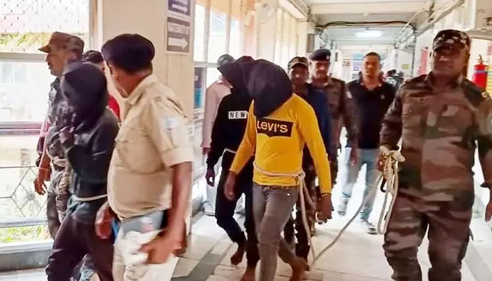 Policemen take three men to the Dumka district court on March 4, 2024, for allegedly brutally assaulting a Spanish woman in the Indian state of Jharkhand. — AFP