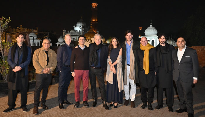 Peruvian fashion photographer Mario Testino posing for a group picture along with  JS Banks Employees on March 6, 2024. — Facebook/JS Bank