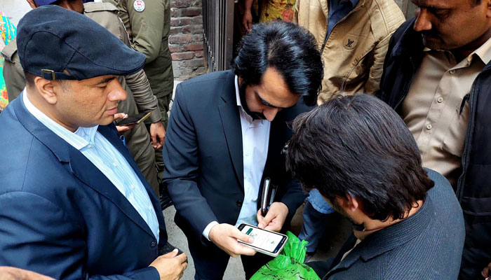 In this image Commissioner Lahore M Ali Randhawa reviews the verification process of Ramazan Nigehban package on March 7, 2024. — Facebook/Commissioner Lahore,Punjab.