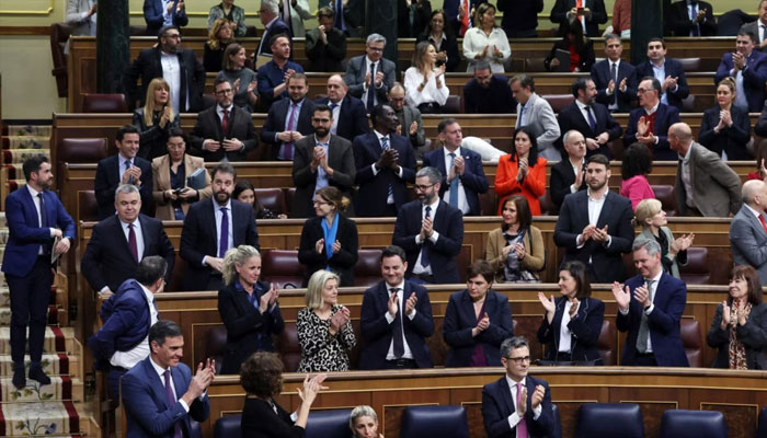 Members of the Socialist parliamentary group applaud at the end of a plenary session of Spains legislature during which an amnesty bill that exonerates figures linked to Catalonias 2017 failed secession bid was approved, in Madrid, March 14, 2024. — AFP