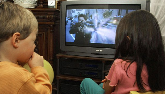 Two British kids watching TV.—AFP/File