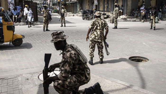 This photo shows the Nigerian Armed Forces taking up positions and securing the street. — AFP/File