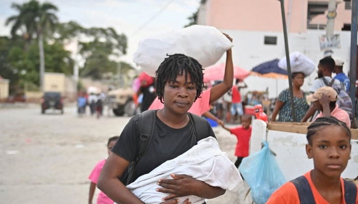 People flee gang violence in the Pétion-Ville neighborhood of Port-au-Prince on January 30, 2024. — AFP