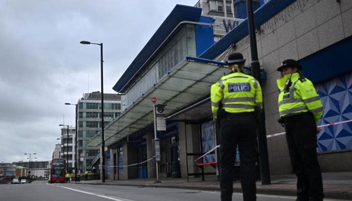 Police officers stand on duty at a police cordon outside the Whitgift Centre on Wellesley Road in Croydon, south London, on September 28, 2023. — AFP