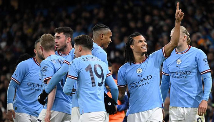 Manchester Citys Nathan Ake (2ndR) celebrates with teammates during the English FA Cup fourth round football match againstArsenal at the Etihad Stadium in Manchester, England, on January 27, 2023. — AFP