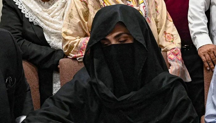 Bushra Bibi sign a surety bond for bail in various cases at the registrars office at the Lahore High Court on July 17, 2023. — AFP