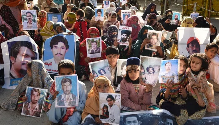 A representational image showing relatives of missing persons holding pictures of their loved ones duing a demonstration. — AFP/File
